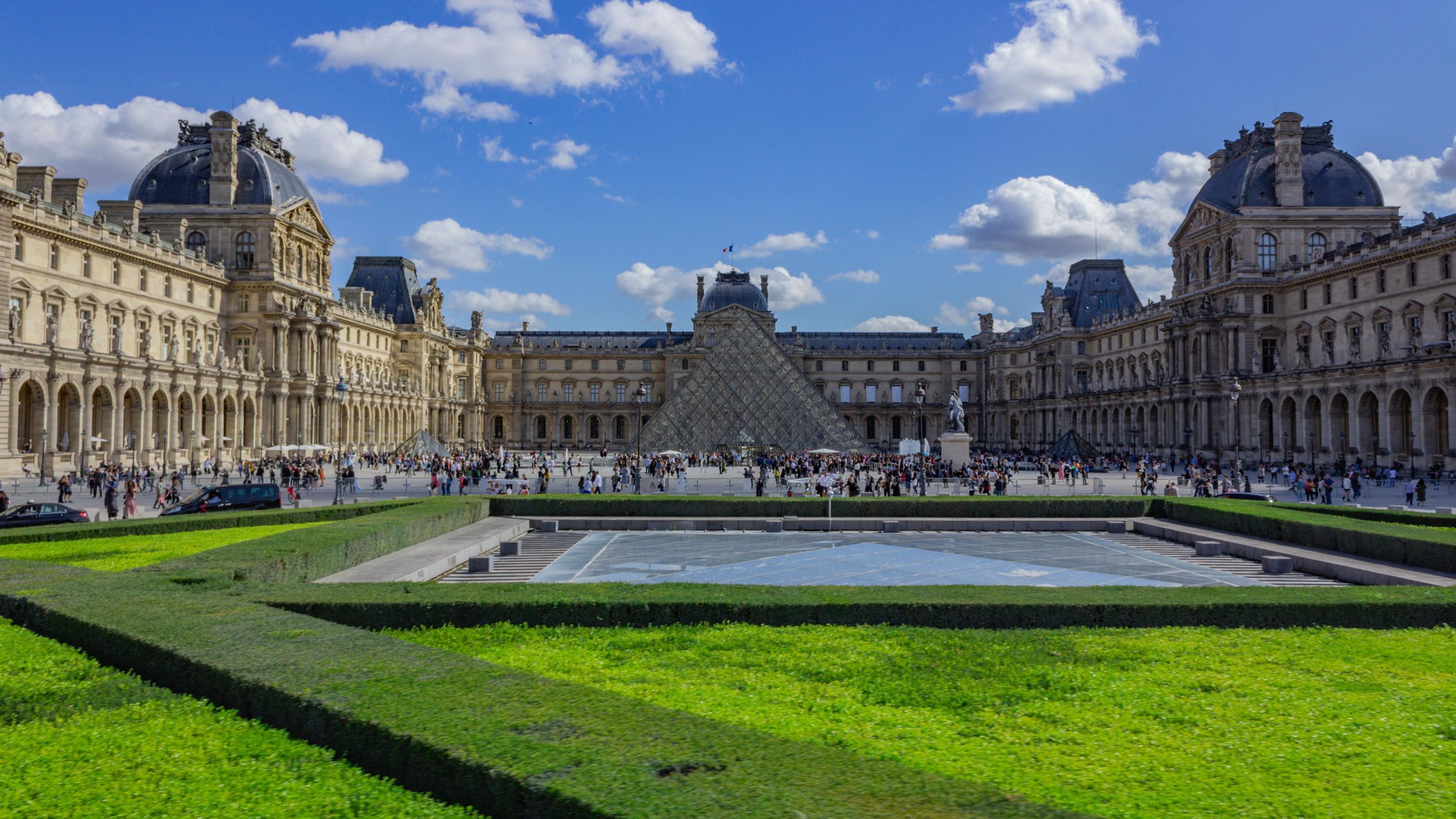 A scenic view of the Louvre Museum at the heart of Paris, France in daylight
