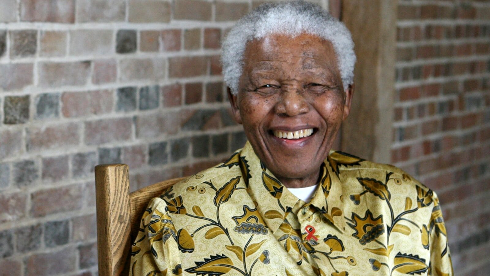 Late South African president Nelson Mandela smiles as he poses for a portrait in London.