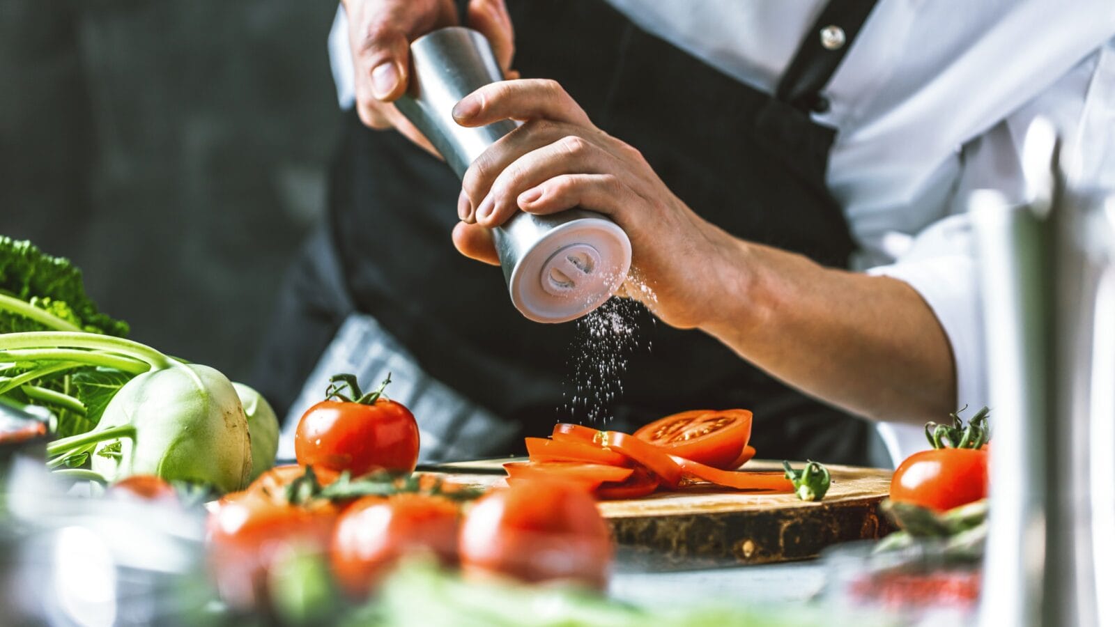 Person preparing vegetables in kitchen.