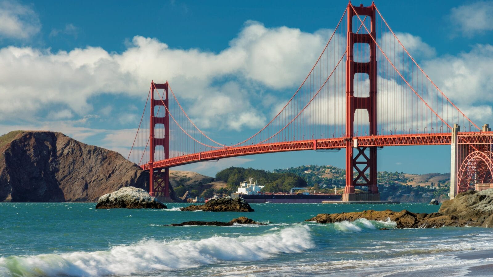Golden Gate Bridge at sunset seen from San Francisco beach, California.
