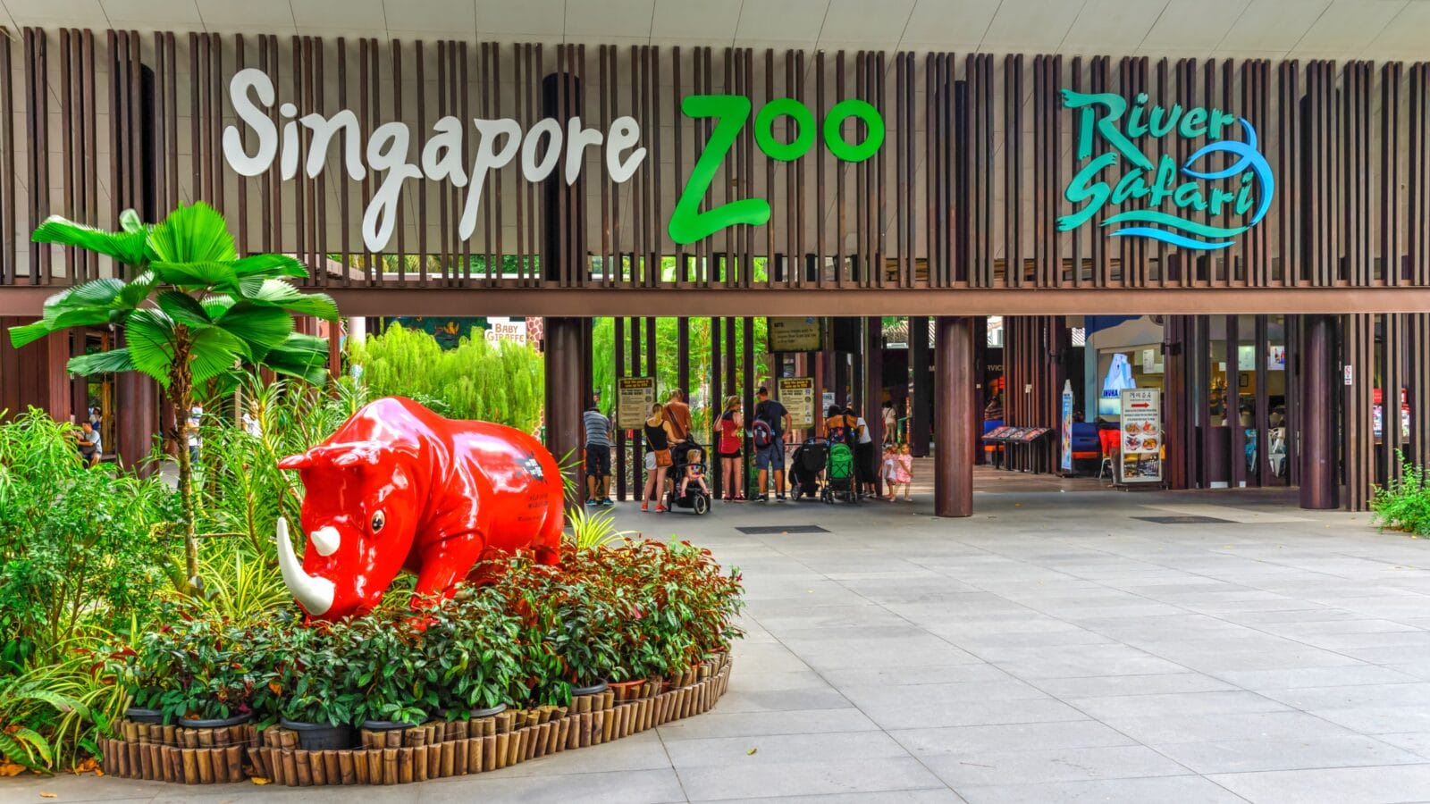 Entrance to Singapore Zoo with red rhino sculpture from wildlife reserves.