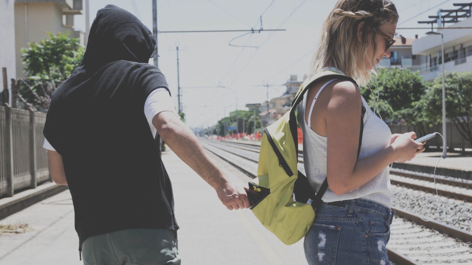 Thief is stealing the wallet to a girl at the station