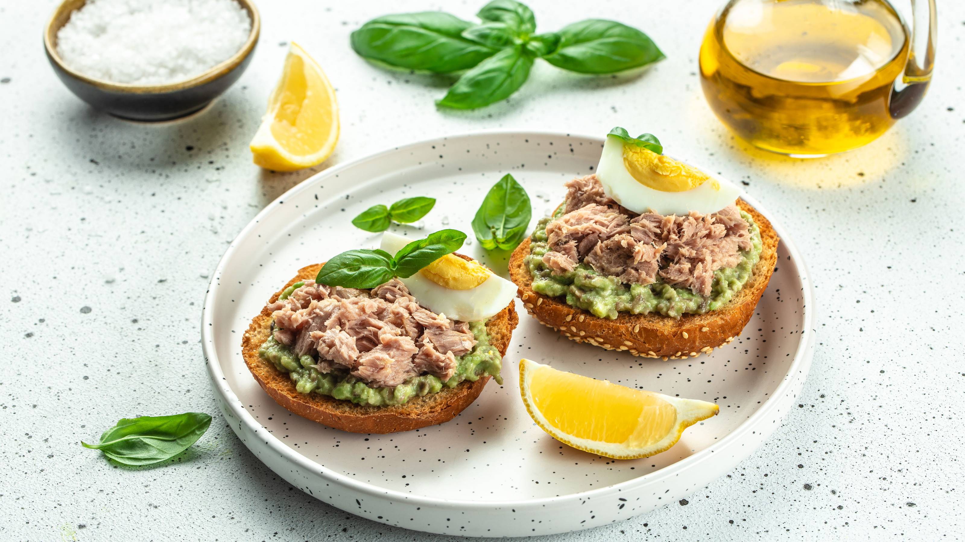 Open sandwiches with canned tuna, boiled egg, avocado for snack or lunch.