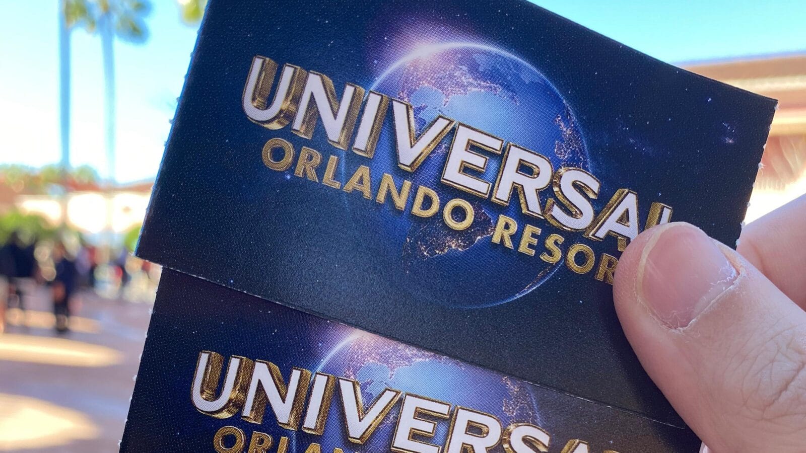 Hand holding 'Universal Studios tickets' famous world theme park and movie company- Orlando, USA