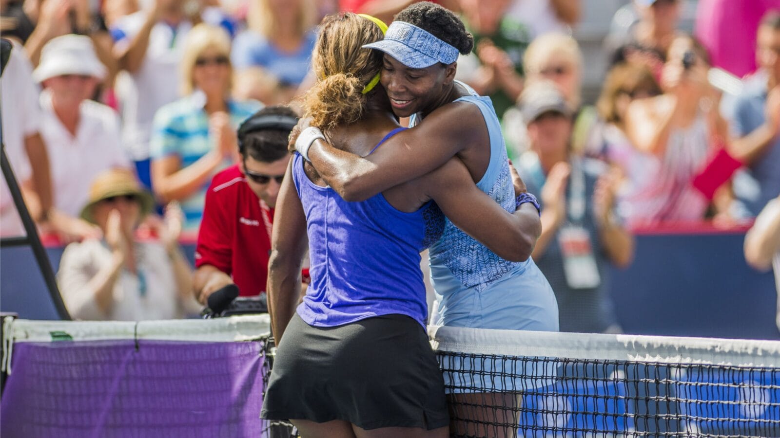 Venus Williams of USA hugs her sister Serena Williams