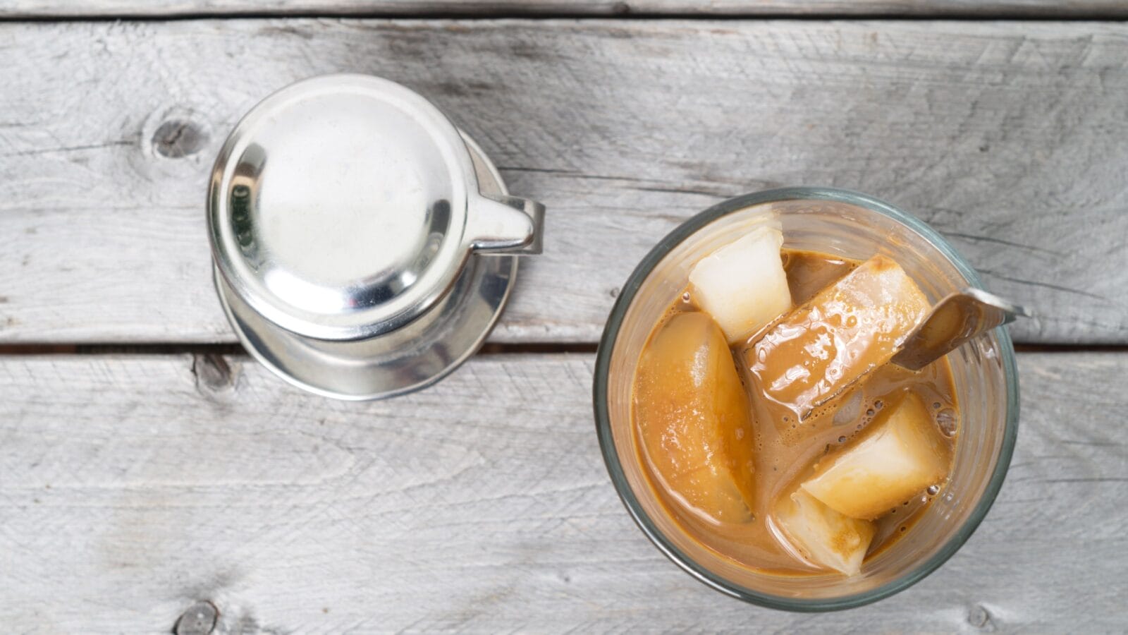 Vietnamese ice coffee with condensed milk, cafe sua da on a wooden background
