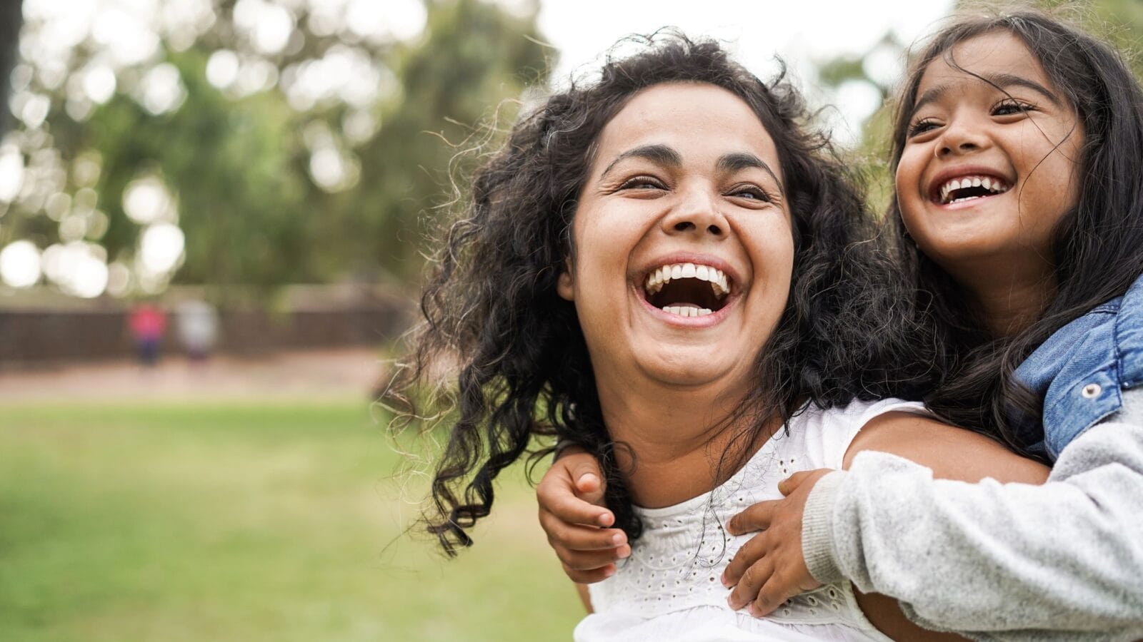 Happy indian mother having fun with her daughter outdoor - Family and love concept - Focus on mum face