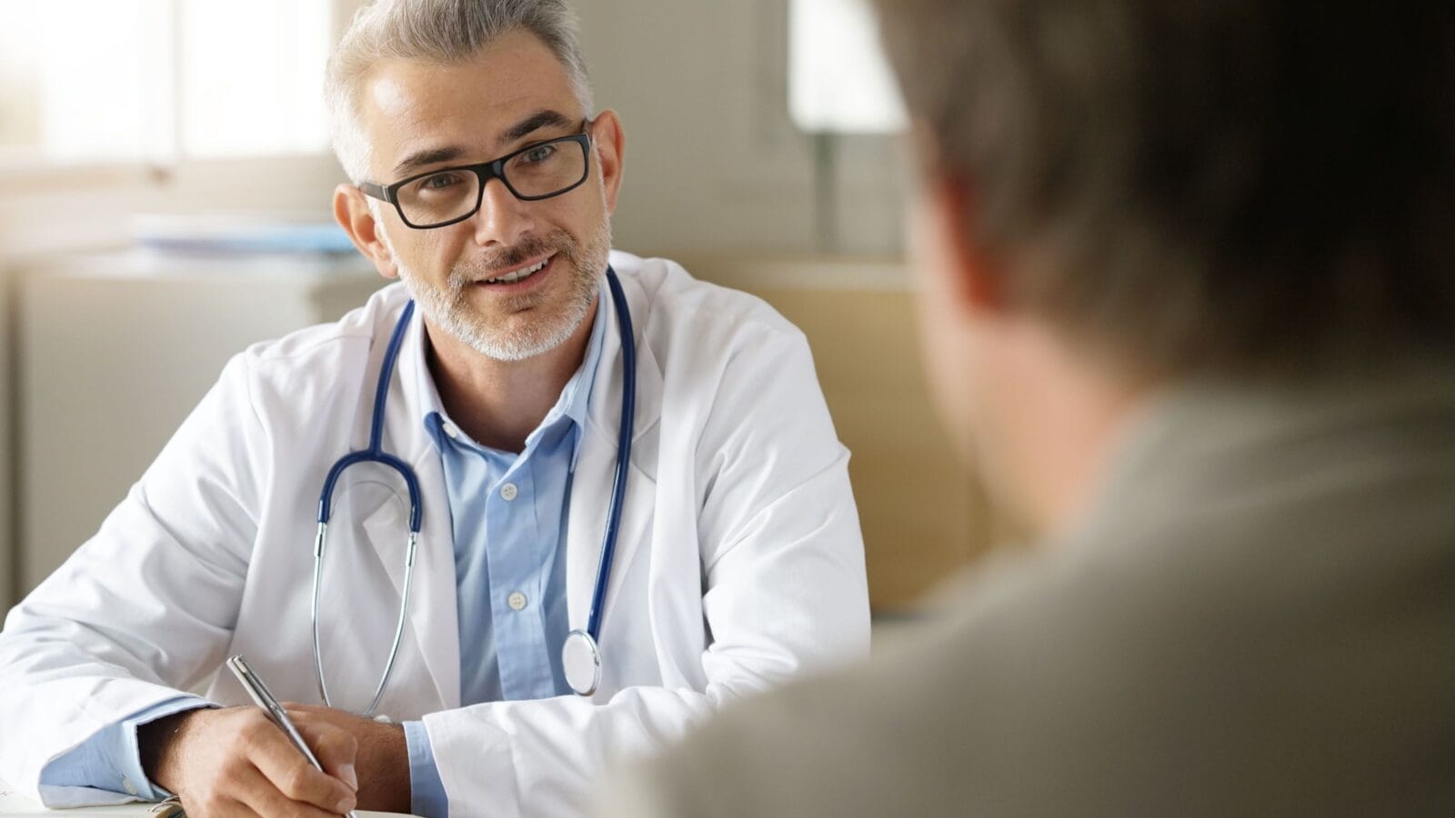 Doctor talking to patient in office