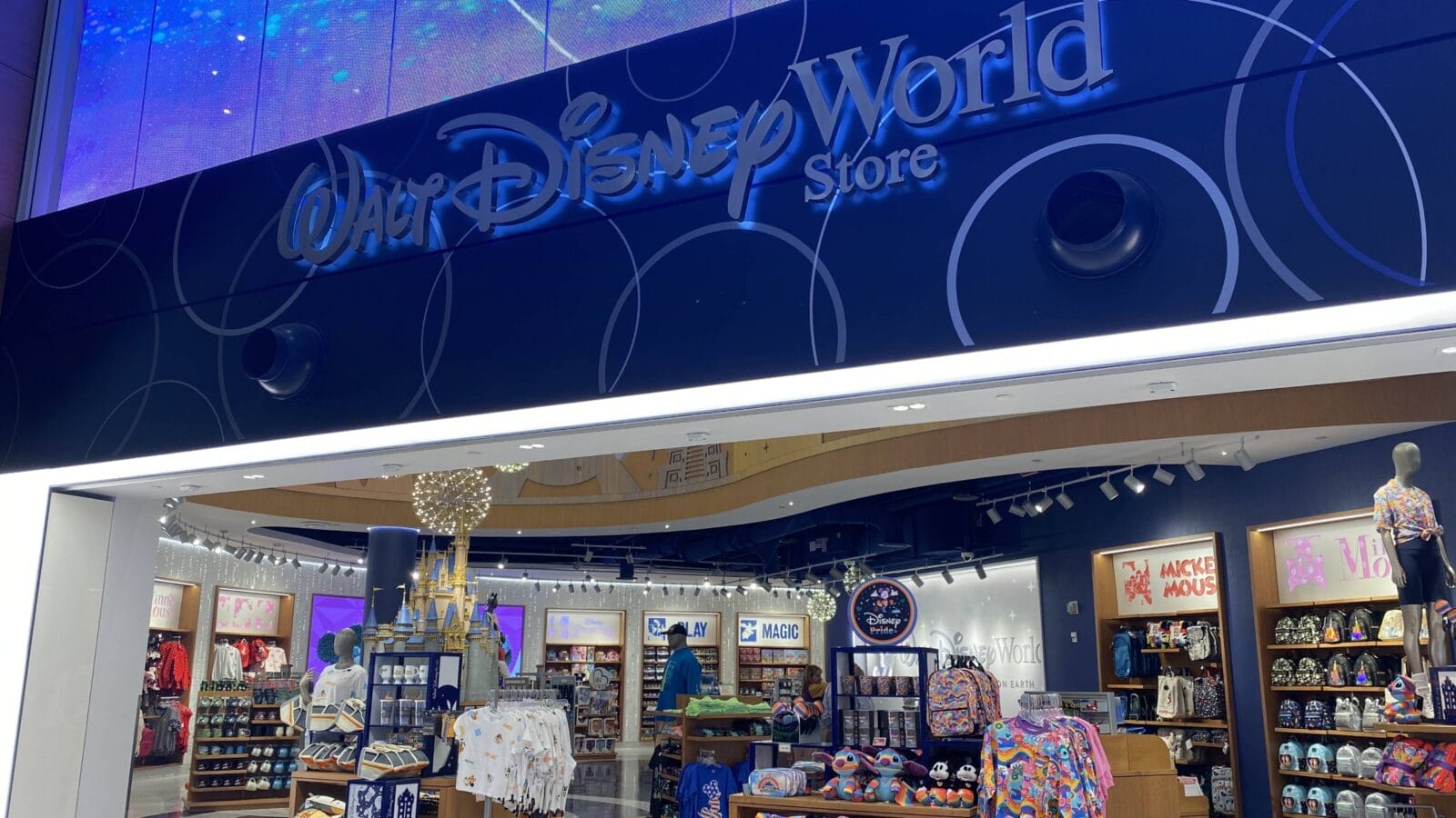 A Walt Disney World Resort Store with a collection of Pride merchandise at the Orlando International Airport.