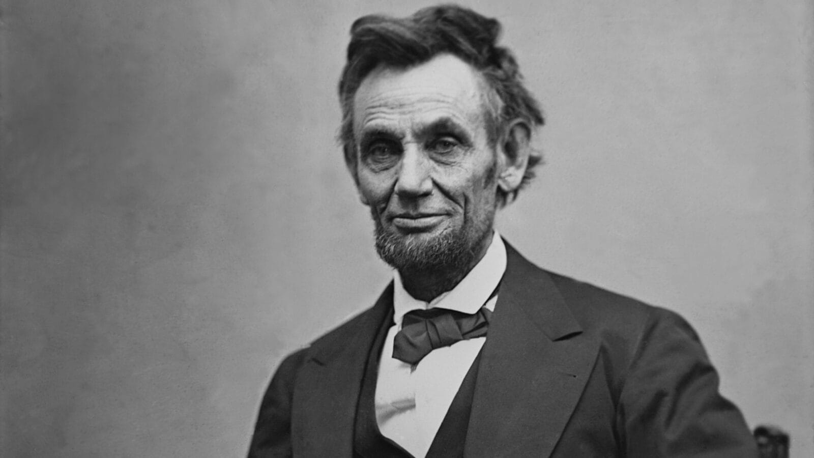 Abraham Lincoln (1809-1865) seated and holding his spectacles and a pencil on Feb. 5, 1865 in portrait by Alexander Gardner.