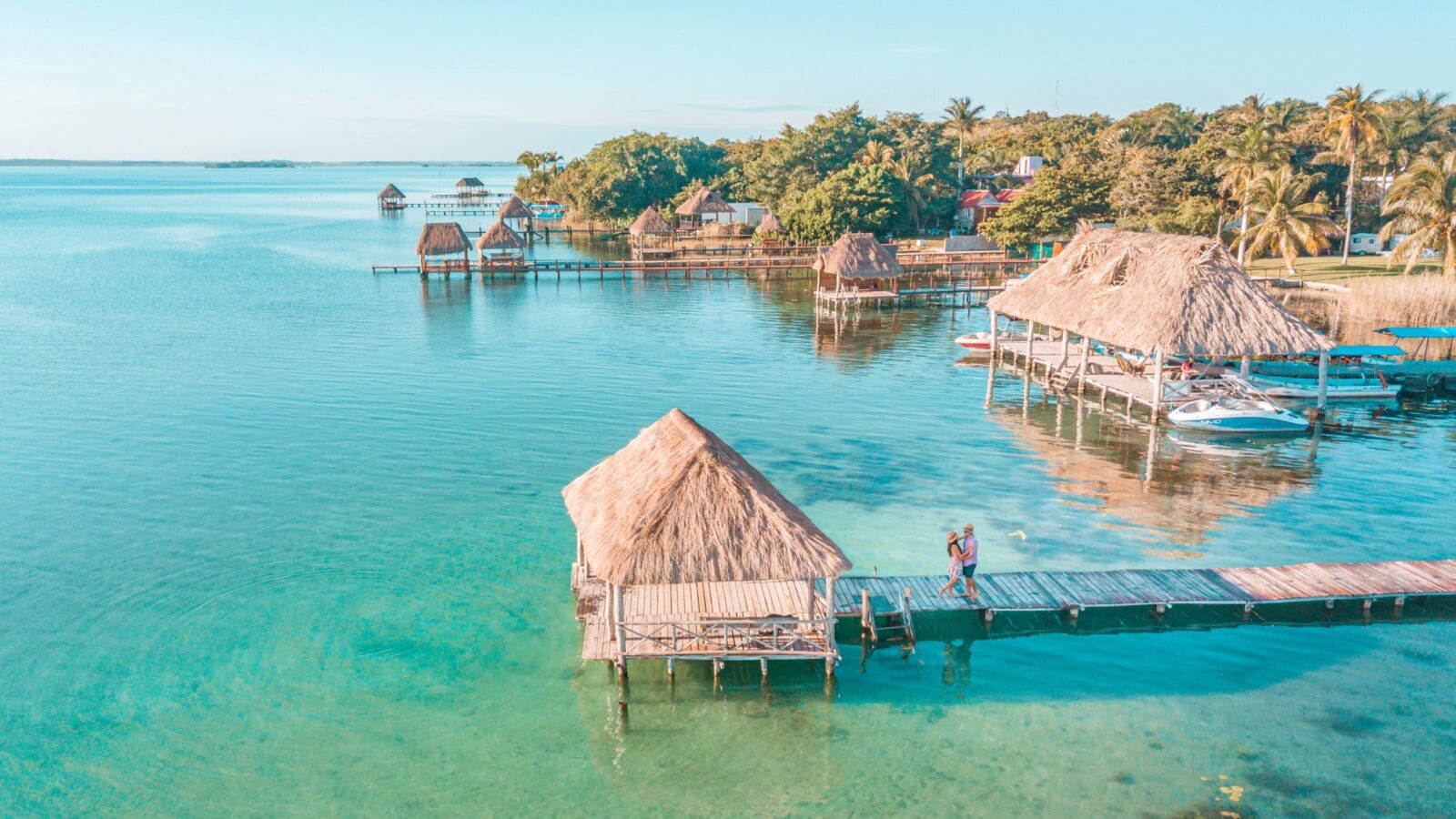 Aerial view of a Couple in Bacalar pier, Riviera Maya, Mexico