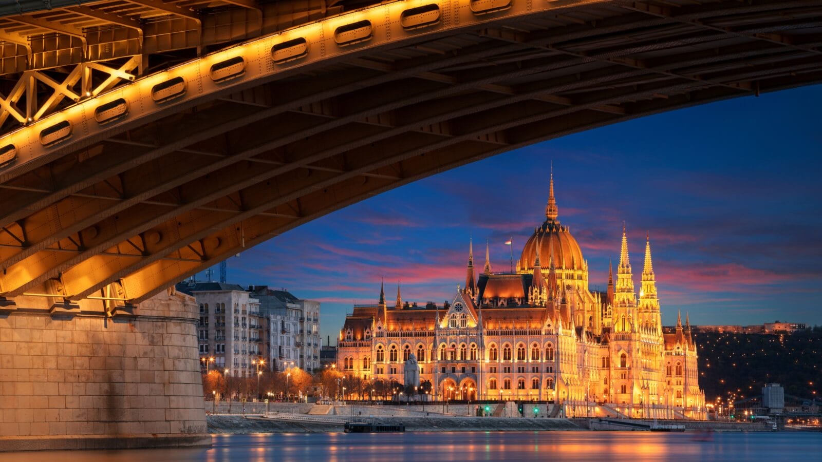 Cityscape image of Budapest, capital city of Hungary with Margaret Bridge and Hungarian Parliament Building at sunset.