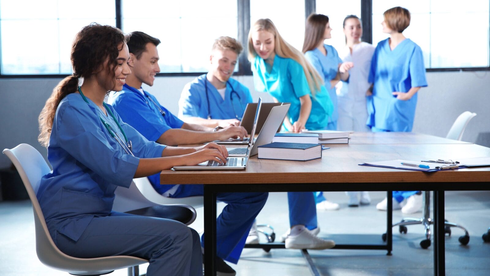 Group of smart medical students with gadgets in college