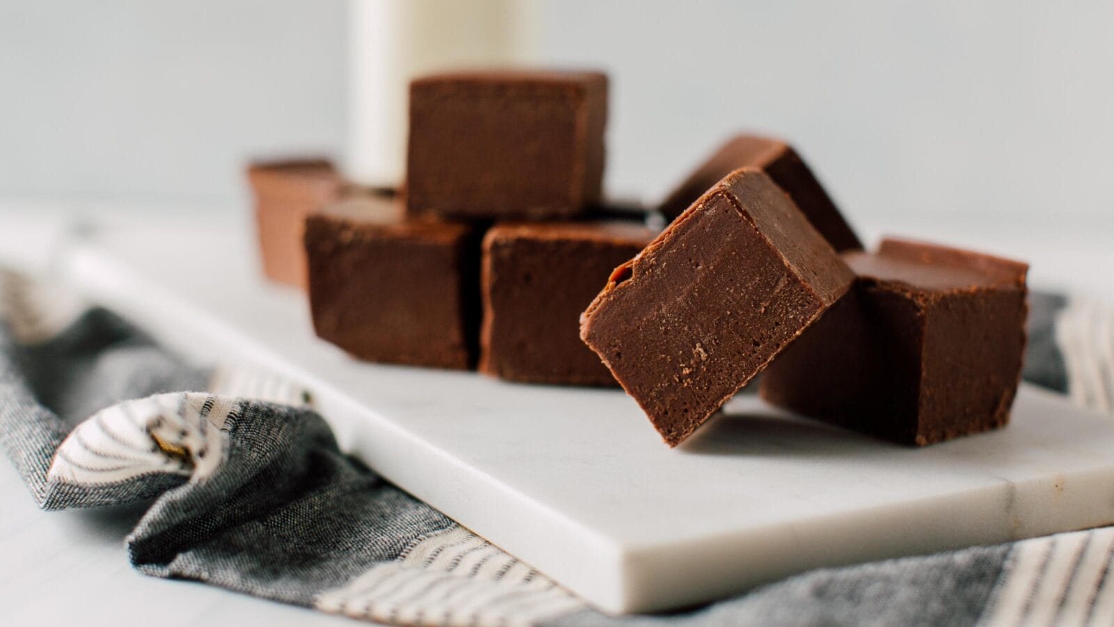 Homemade Fudge cubes on white plate.
