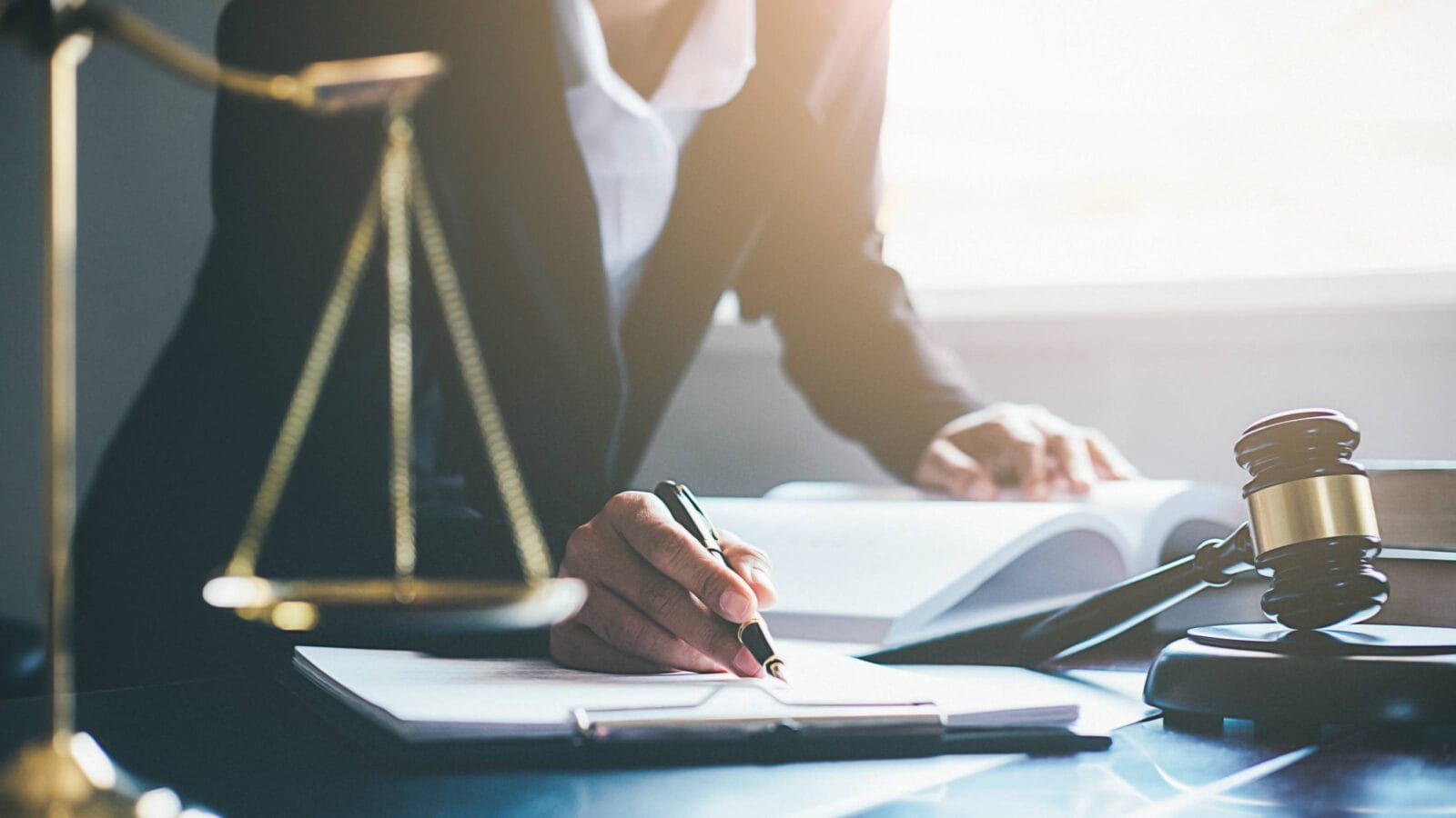 Legal counsel presents to the client a signed contract with gavel and legal law