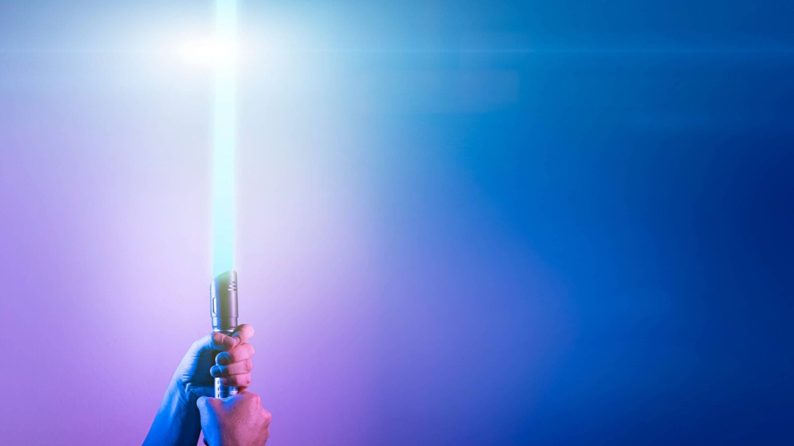 a fantastic laser sword lightsaber in the hands of a man