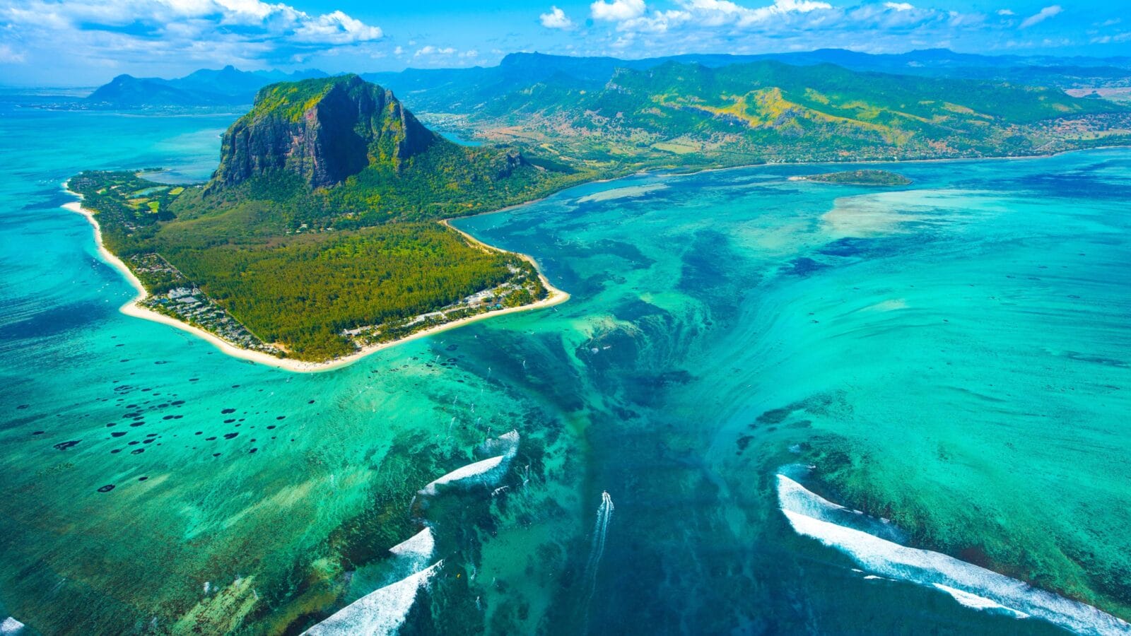 Aerial view of Mauritius island and Le Morne Brabant mountain with beautiful blue lagoon and underwater waterfall illusion