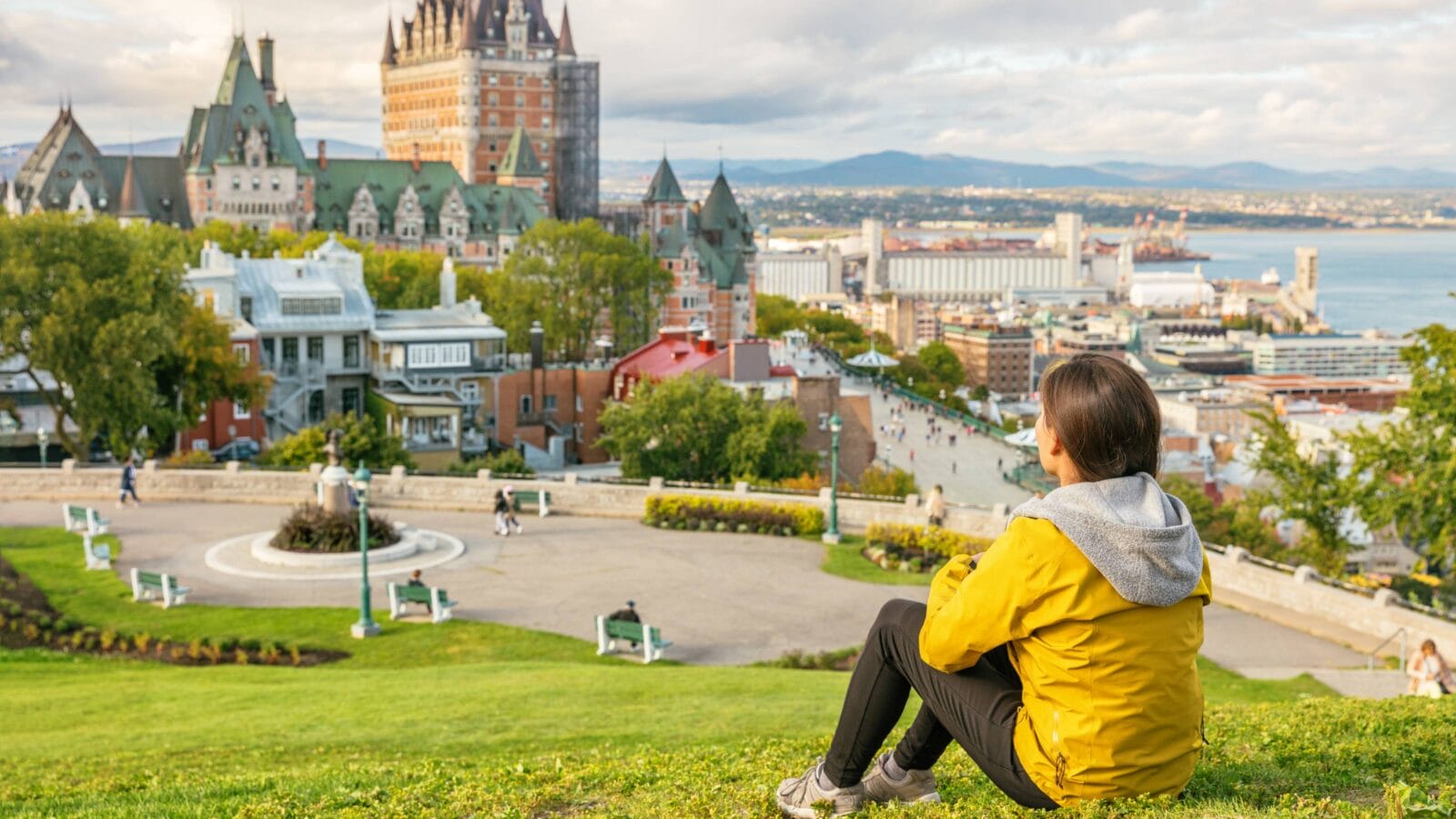 Canada travel Quebec city tourist enjoying view of Chateau Frontenac castle and St. Lawrence river in background.