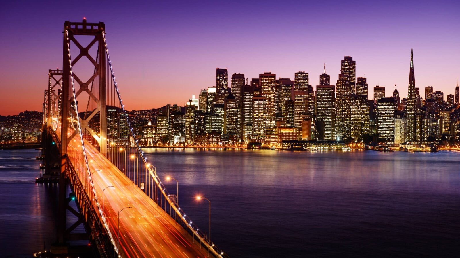 San Francisco skyline and Bay Bridge at sunset, California