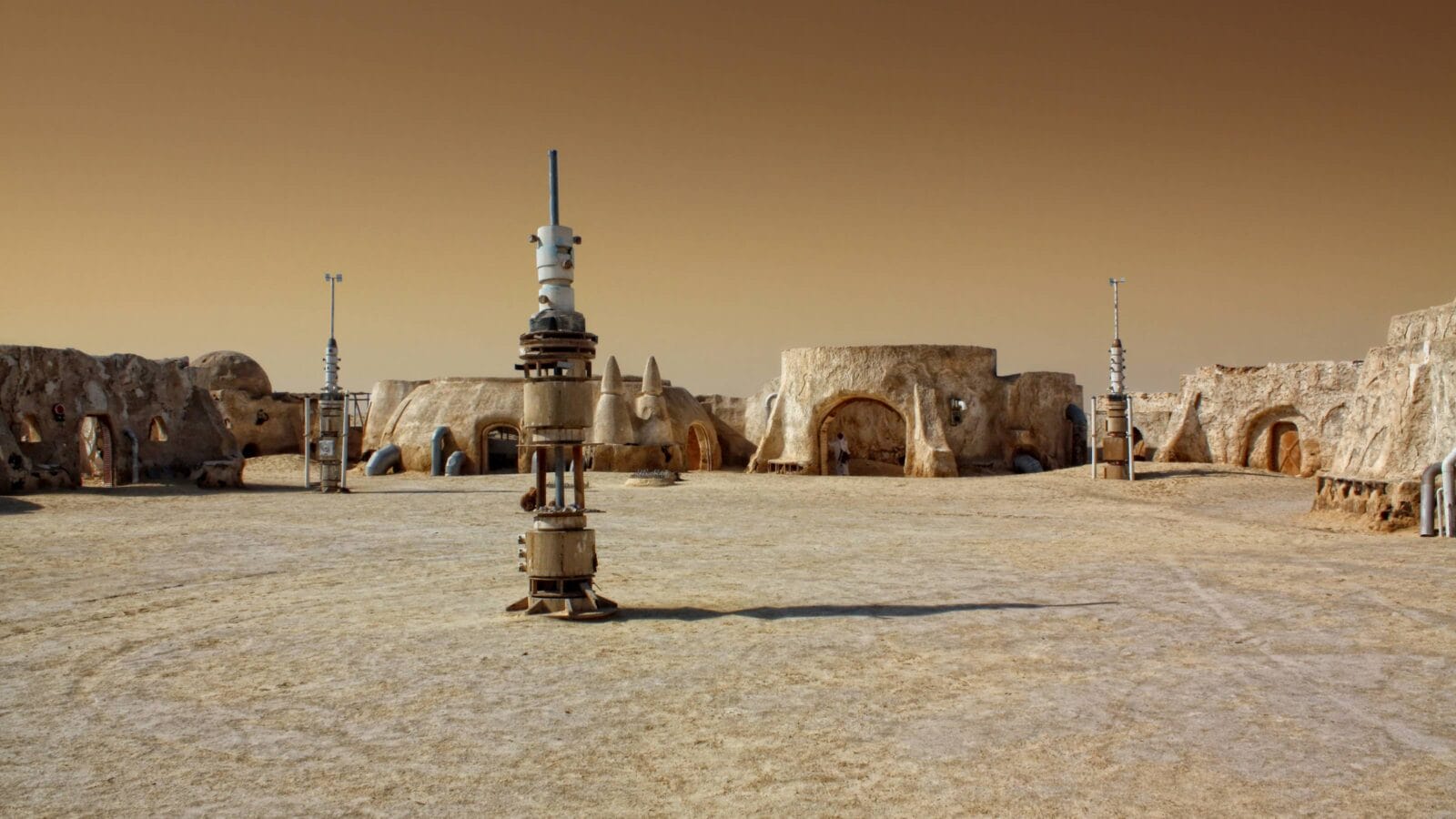 Abandoned sets for the shooting of the movie Star Wars in the Sahara desert on a background of sand dunes.