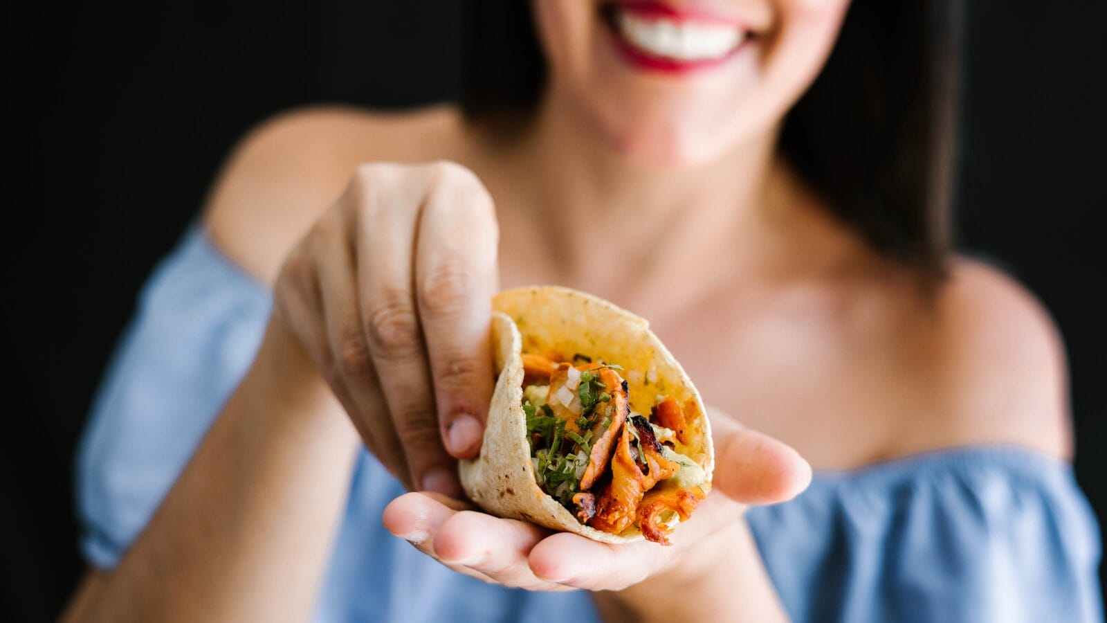 Mexican woman eating tacos al pastor, mexican food in Mexico Latin America