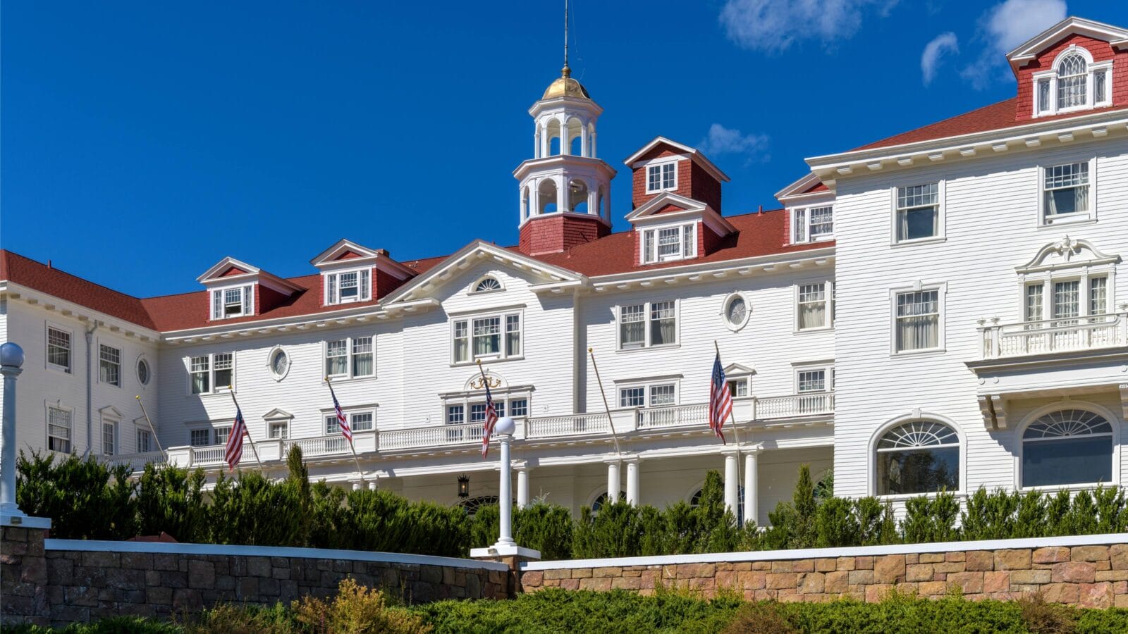 A closeup wide-angle front-side view of the famous Stanley Hotel on a bright sunny Autumn day.