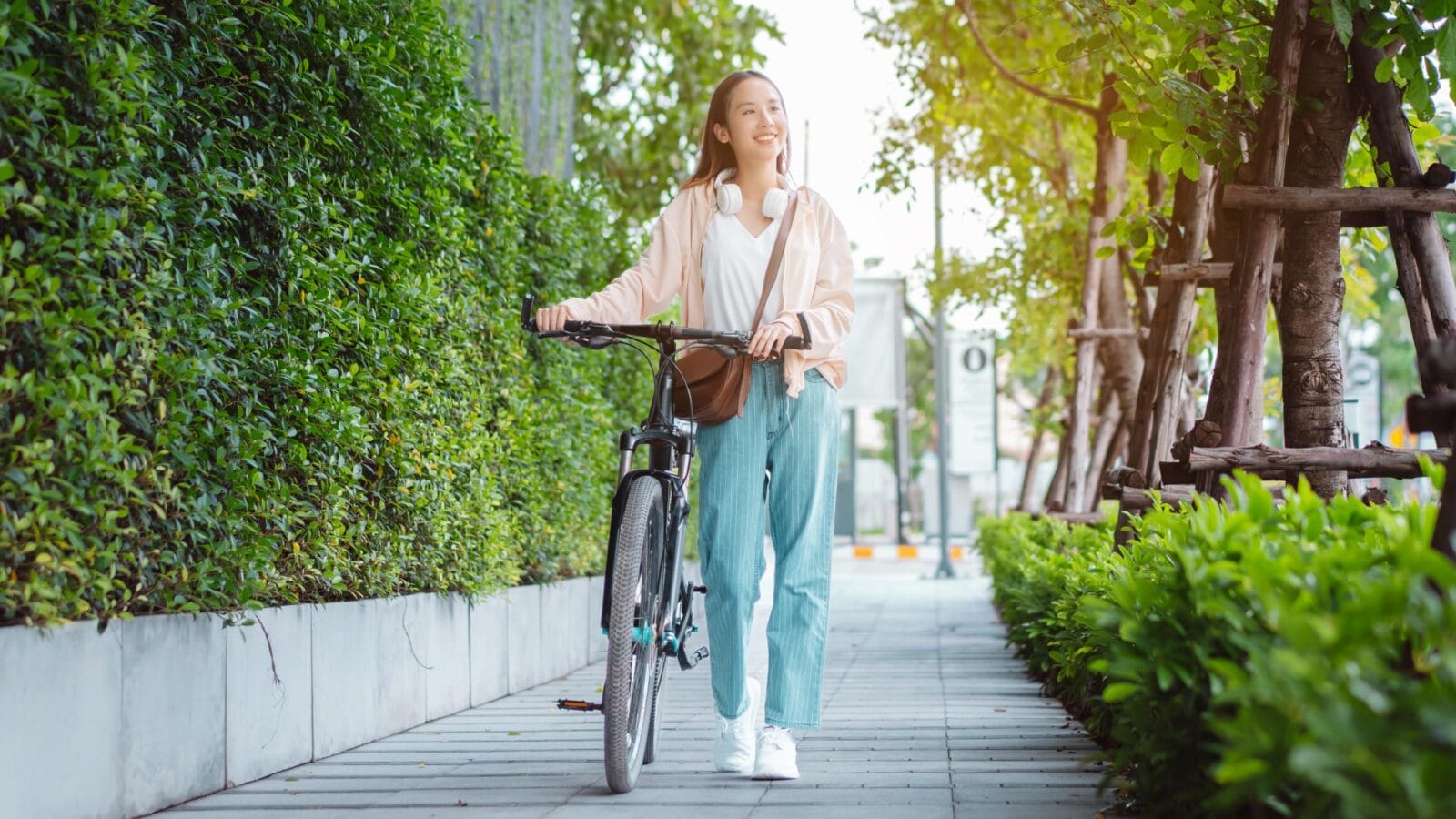 Happy Asian young woman walk and ride bicycle in park, street city her smiling using bike of transportation, ECO friendly