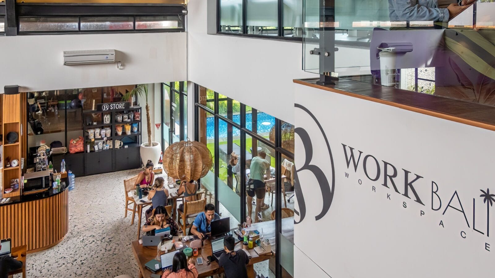 People sitting in a shared coworking space cafe and cultural center, Canggu, Bali, Indonesia