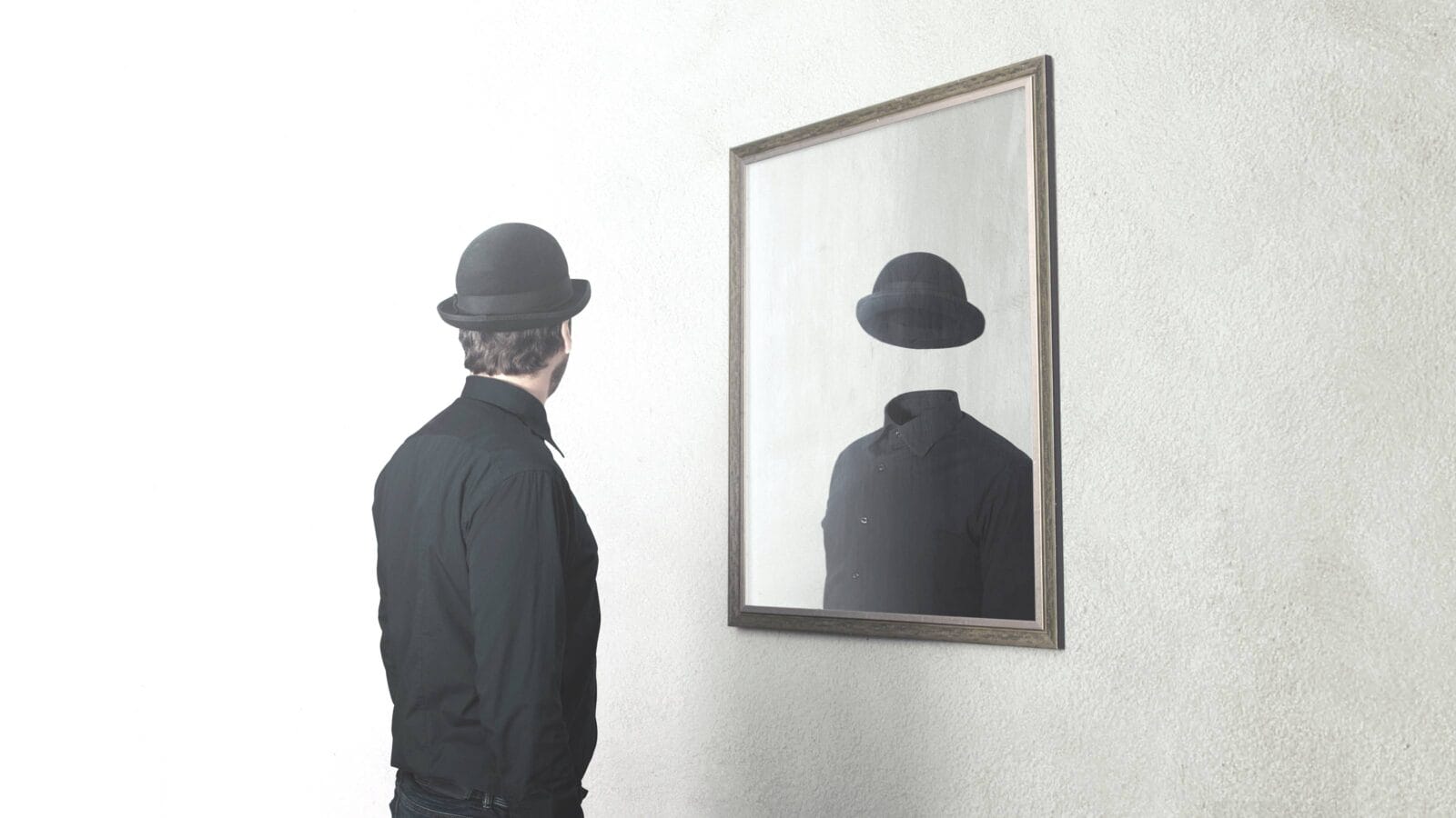 man in front of mirror reflecting himself without face
